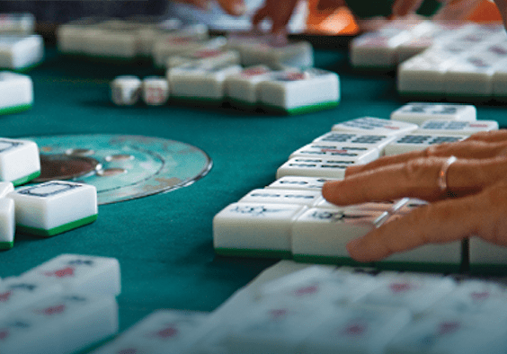 close up of people playing mahjong