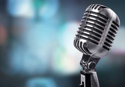 close up of a microphone on a lit stage