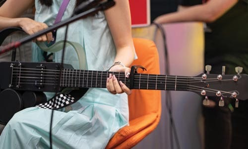 close up of a woman playing a guitar