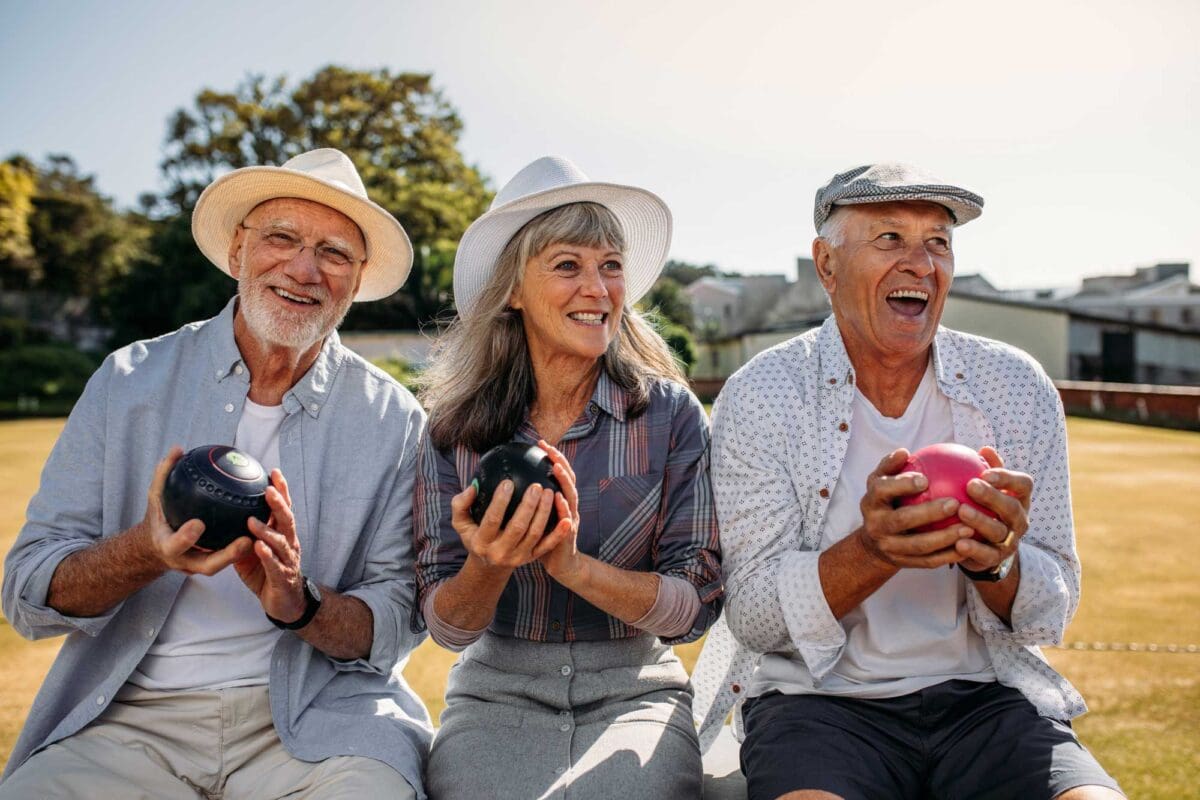 a group of senior friends playing bocce ball together