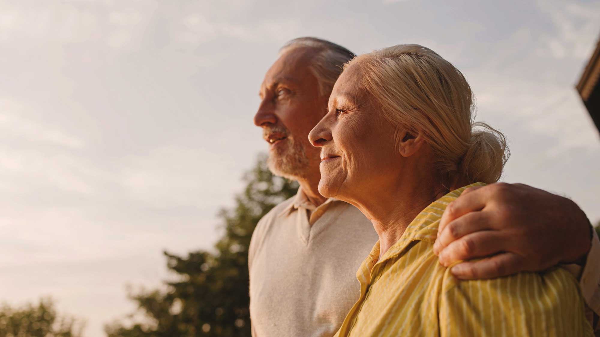 senior couple watching the sun set together