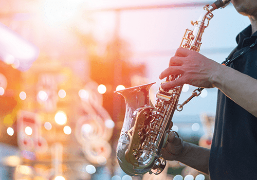 close up of a man playing the saxophone during a jazz concert