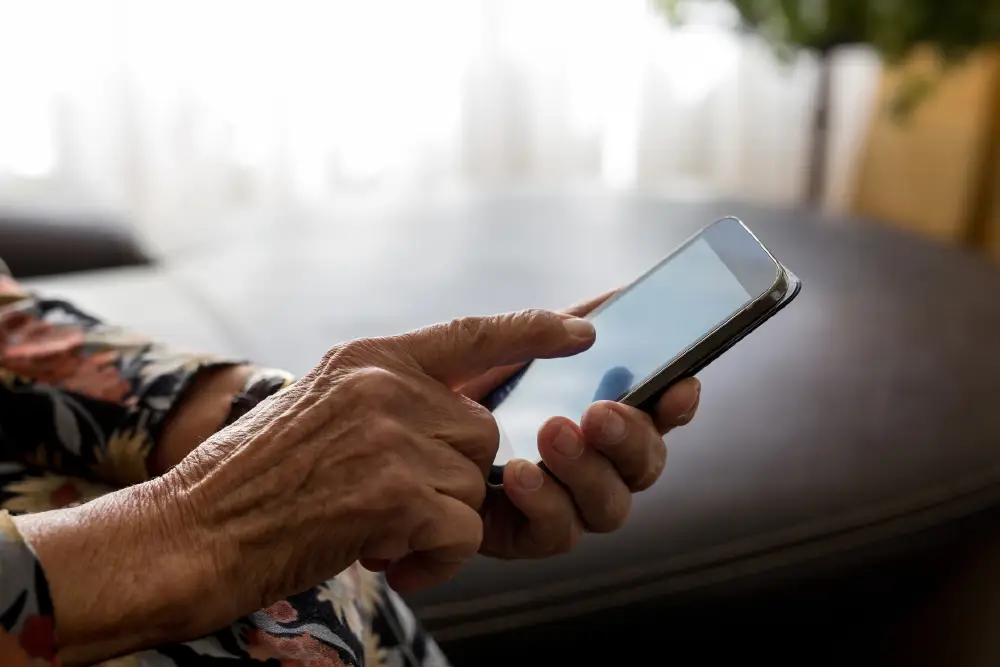 close up of a senior using their smart phone